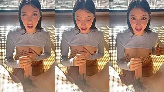 hot babe Ruth Lee jerking off a big cock in the sun